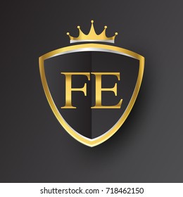 Initial logo letter FE with shield and crown Icon golden color isolated on black background, logotype design for company identity.