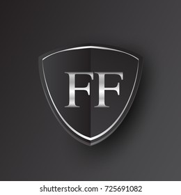 Initial logo letter FF with shield Icon silver color isolated on black background, logotype design for company identity.