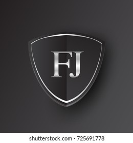 Initial logo letter FJ with shield Icon silver color isolated on black background, logotype design for company identity.