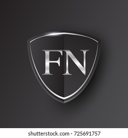 Initial logo letter FN with shield Icon silver color isolated on black background, logotype design for company identity.