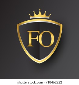 Initial logo letter FO with shield and crown Icon golden color isolated on black background, logotype design for company identity.