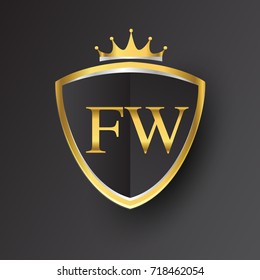 Initial logo letter FW with shield and crown Icon golden color isolated on black background, logotype design for company identity.