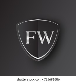 Initial logo letter FW with shield Icon silver color isolated on black background, logotype design for company identity.