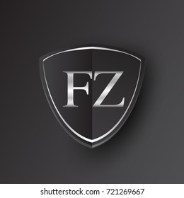 Initial logo letter FZ with shield Icon silver color isolated on black background, logotype design for company identity.