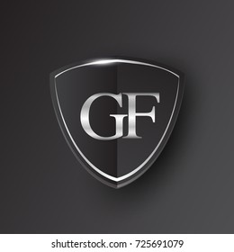 Initial logo letter GF with shield Icon silver color isolated on black background, logotype design for company identity.