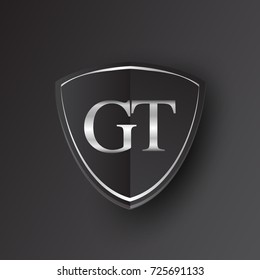 Initial logo letter GT with shield Icon silver color isolated on black background, logotype design for company identity.