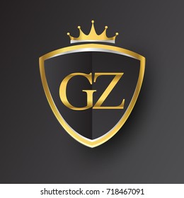 Initial logo letter GZ with shield and crown Icon golden color isolated on black background, logotype design for company identity.