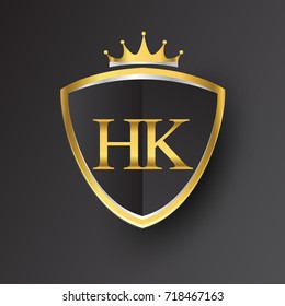 Initial logo letter HK with shield and crown Icon golden color isolated on black background, logotype design for company identity.