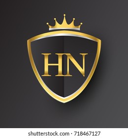 Initial logo letter HN with shield and crown Icon golden color isolated on black background, logotype design for company identity.