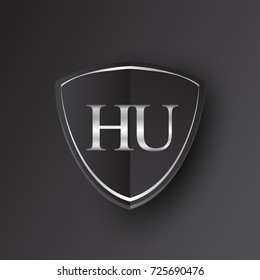 Initial logo letter HU with shield Icon silver color isolated on black background, logotype design for company identity.