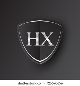 Initial logo letter HX with shield Icon silver color isolated on black background, logotype design for company identity.
