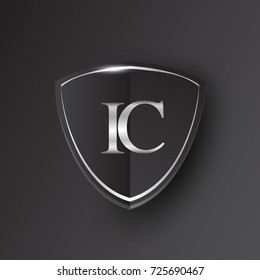 Initial logo letter IC with shield Icon silver color isolated on black background, logotype design for company identity.