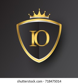 Initial logo letter IO with shield and crown Icon golden color isolated on black background, logotype design for company identity.