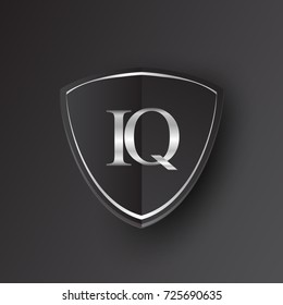 Initial logo letter IQ with shield Icon silver color isolated on black background, logotype design for company identity.