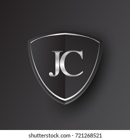 Initial logo letter JC with shield Icon silver color isolated on black background, logotype design for company identity.