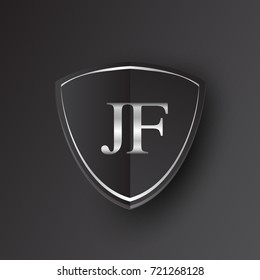 Initial logo letter JF with shield Icon silver color isolated on black background, logotype design for company identity.