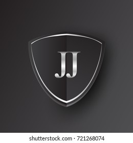 Initial logo letter JJ with shield Icon silver color isolated on black background, logotype design for company identity.