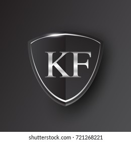 Initial logo letter KF with shield Icon silver color isolated on black background, logotype design for company identity.