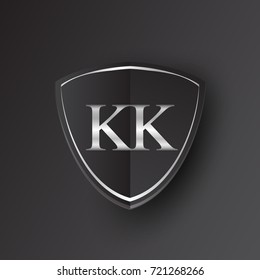 Initial logo letter KK with shield Icon silver color isolated on black background, logotype design for company identity.