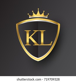 Initial logo letter KL with shield and crown Icon golden color isolated on black background.