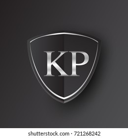 Initial logo letter KP with shield Icon silver color isolated on black background, logotype design for company identity.