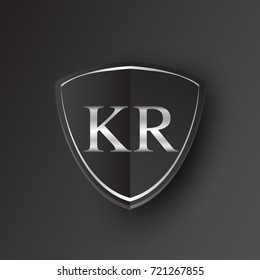 Initial logo letter KR with shield Icon silver color isolated on black background, logotype design for company identity.