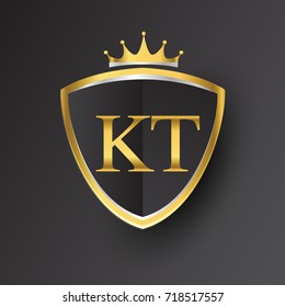 Initial logo letter KT with shield and crown Icon golden color isolated on black background, logotype design for company identity.