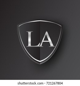 Initial logo letter LA with shield Icon silver color isolated on black background, logotype design for company identity.