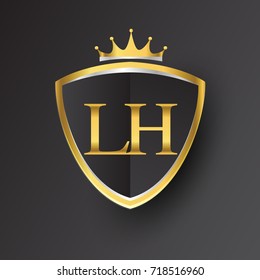 Initial logo letter LH with shield and crown Icon golden color isolated on black background, logotype design for company identity.