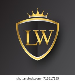 Initial logo letter LW with shield and crown Icon golden color isolated on black background, logotype design for company identity.