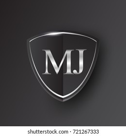 Initial logo letter MJ with shield Icon silver color isolated on black background, logotype design for company identity.