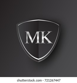 Initial logo letter MK with shield Icon silver color isolated on black background, logotype design for company identity.