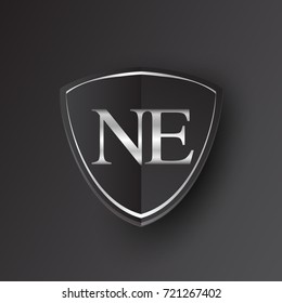 Initial logo letter NE with shield Icon silver color isolated on black background, logotype design for company identity.