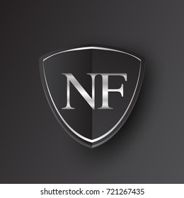 Initial logo letter NF with shield Icon silver color isolated on black background, logotype design for company identity.