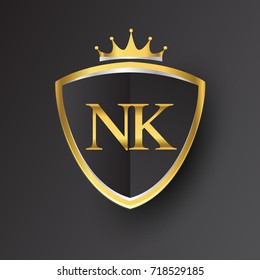 Initial logo letter NK with shield and crown Icon golden color isolated on black background, logotype design for company identity.