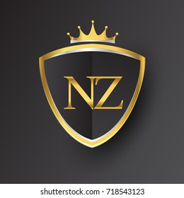 Initial logo letter NZ with shield and crown Icon golden color isolated on black background, logotype design for company identity.