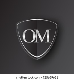 Initial logo letter OM with shield Icon silver color isolated on black background, logotype design for company identity.