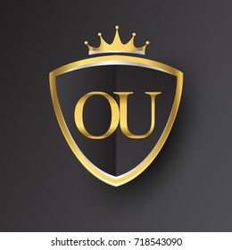 Initial logo letter OU with shield and crown Icon golden color isolated on black background, logotype design for company identity.