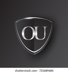 Initial logo letter OU with shield Icon silver color isolated on black background, logotype design for company identity.