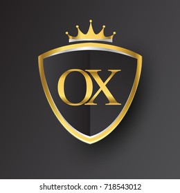 Initial logo letter OX with shield and crown Icon golden color isolated on black background, logotype design for company identity.