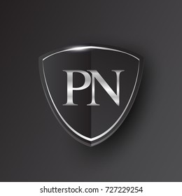 Initial logo letter PN with shield Icon silver color isolated on black background, logotype design for company identity.