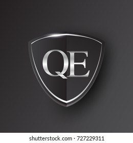 Initial logo letter QE with shield Icon silver color isolated on black background, logotype design for company identity.