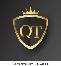 Initial logo letter QT with shield and crown Icon golden color isolated on black background, logotype design for company identity.