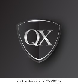 Initial logo letter QX with shield Icon silver color isolated on black background, logotype design for company identity.