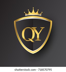 Initial logo letter QY with shield and crown Icon golden color isolated on black background, logotype design for company identity.