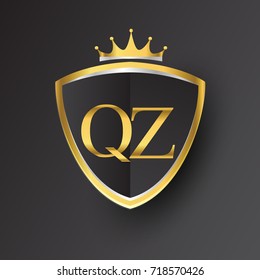 Initial logo letter QZ with shield and crown Icon golden color isolated on black background, logotype design for company identity.