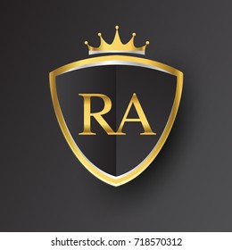 Initial logo letter RA with shield and crown Icon golden color isolated on black background, logotype design for company identity.