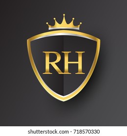 Initial logo letter RH with shield and crown Icon golden color isolated on black background, logotype design for company identity.
