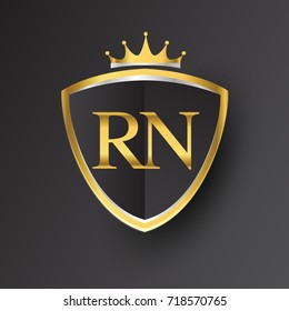 Initial logo letter RN with shield and crown Icon golden color isolated on black background, logotype design for company identity.