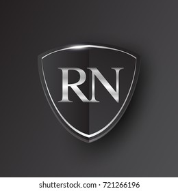 Initial logo letter RN with shield Icon silver color isolated on black background, logotype design for company identity.